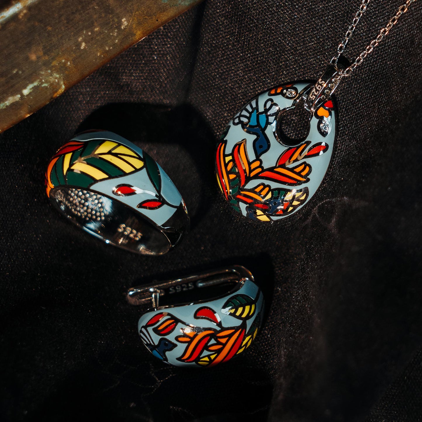 A sterling silver pendant plus earrings plus ring set of enamel of green color with print of birds and leaves