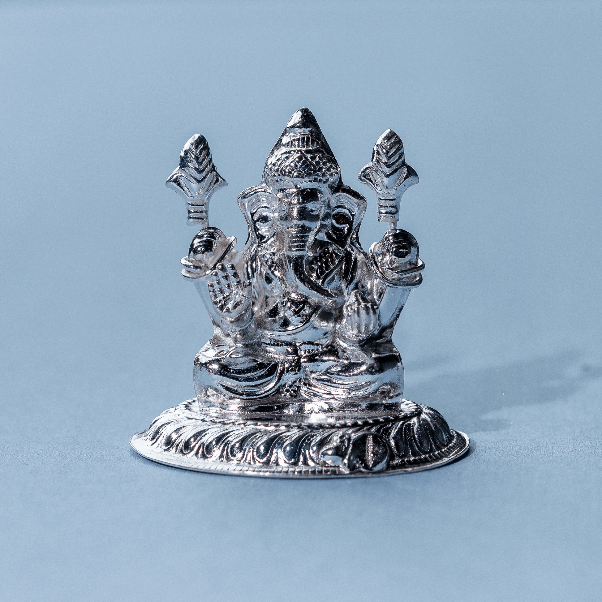 Lord ganesha idol on blue background 