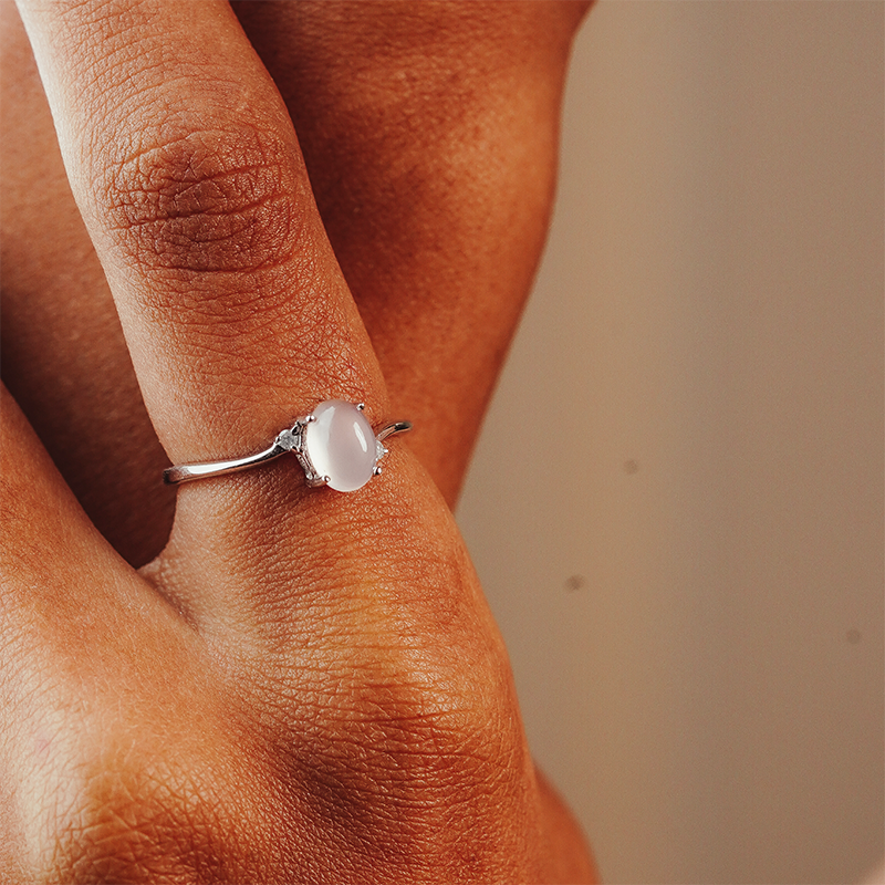 Close-up of a hand wearing a ring with a quarts and two diamonds in the side