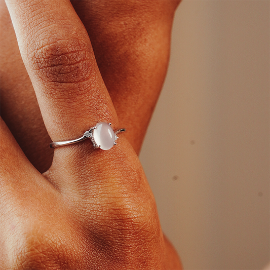 Close-up of a hand wearing a ring with a quarts and two diamonds in the side