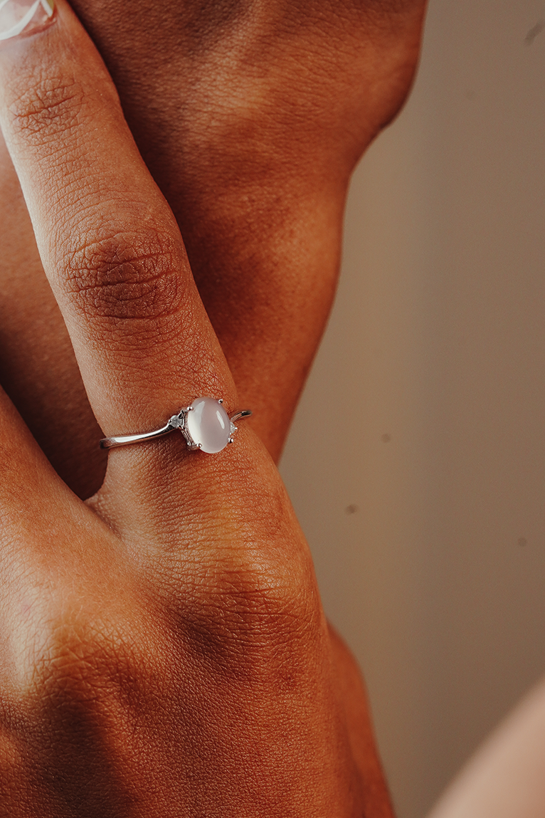 Close-up of a hand wearing a ring with a quarts and two diamonds in the side
