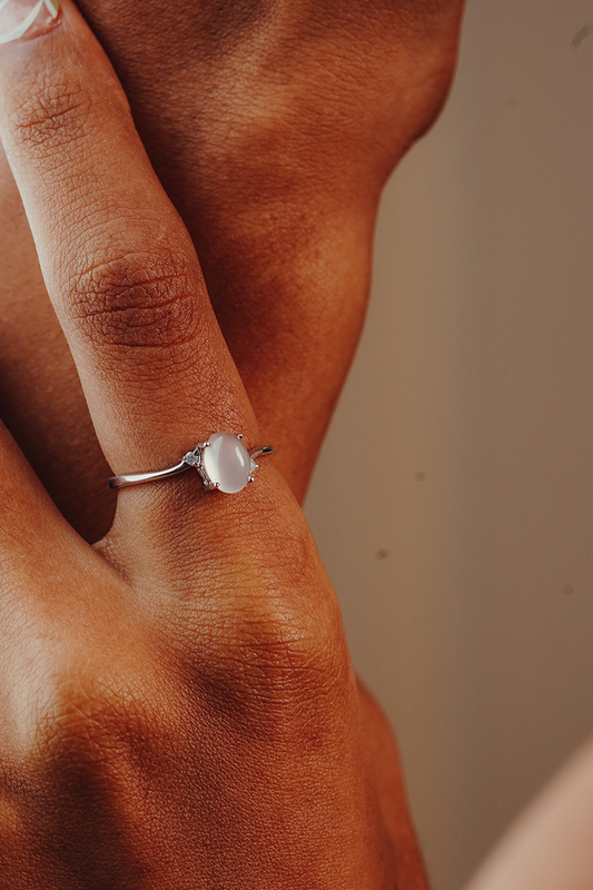 Close-up of a hand wearing a ring with a quarts and two diamonds in the side