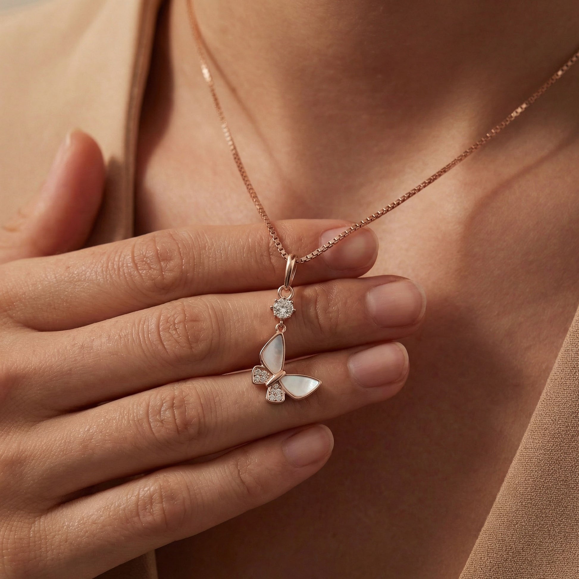 Women admiring elfy's 925 silver butterfly charm