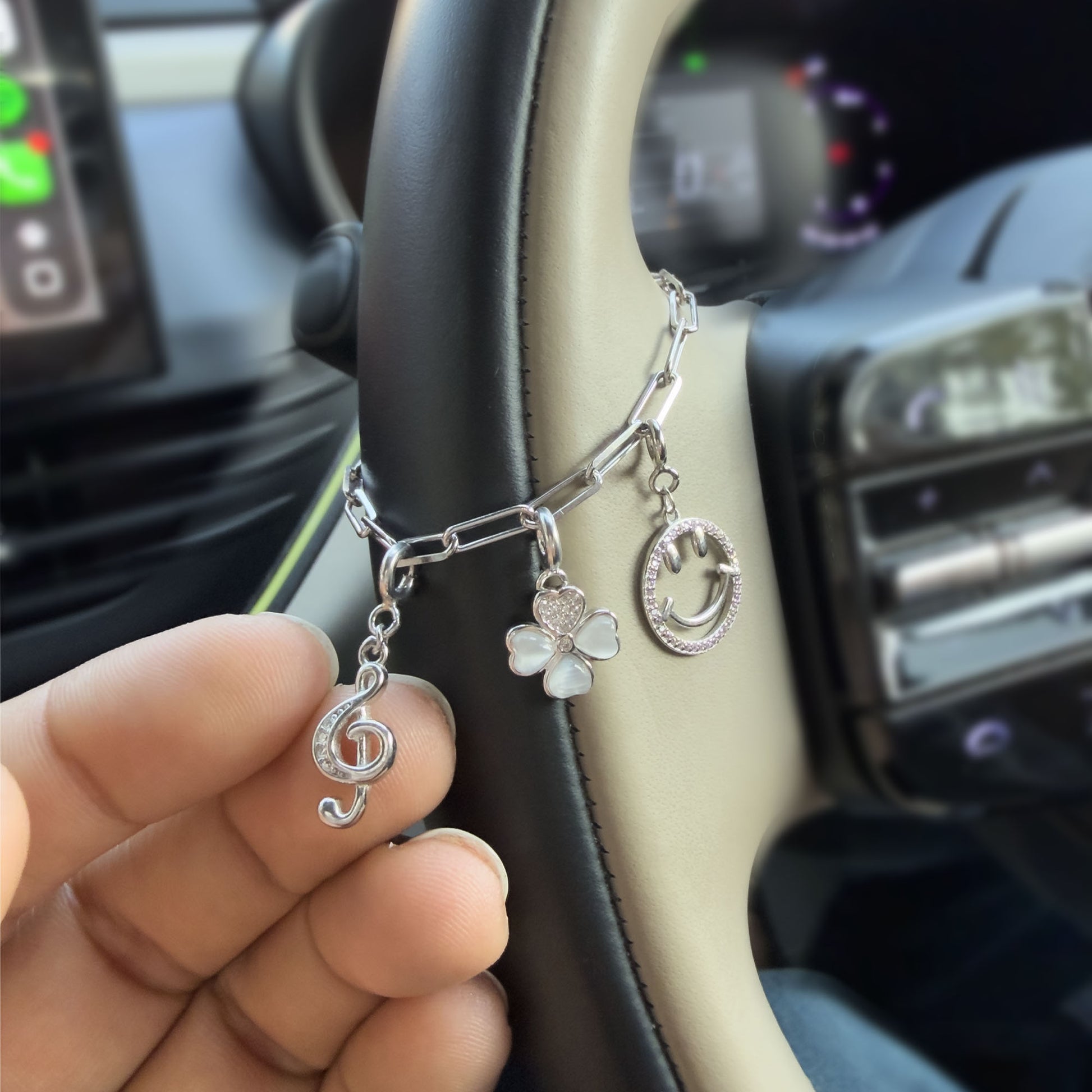 Customizable sterling silver car steering charm chain with decorative charms mounted on steering wheel
