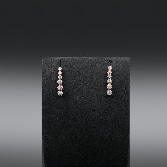 Pair of earrings with zirconia diamonds on a black earring stand