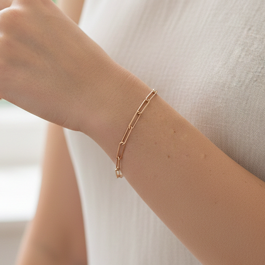 Sterling Silver Paperclip Charm Bracelet in rose gold on models hand