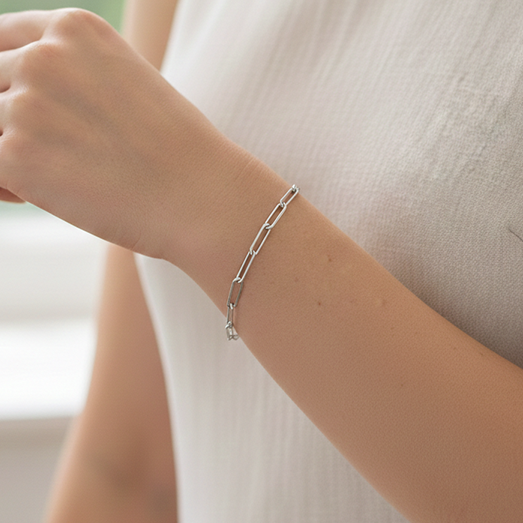 Sterling Silver Paperclip Charm Bracelet on models hand