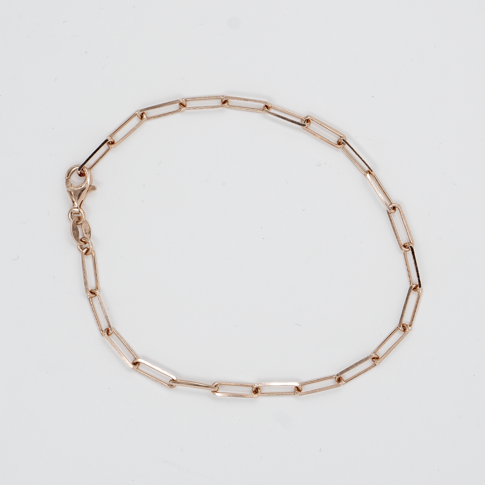 Elfy Paperclip Charm Bracelet in rose gold on a white background