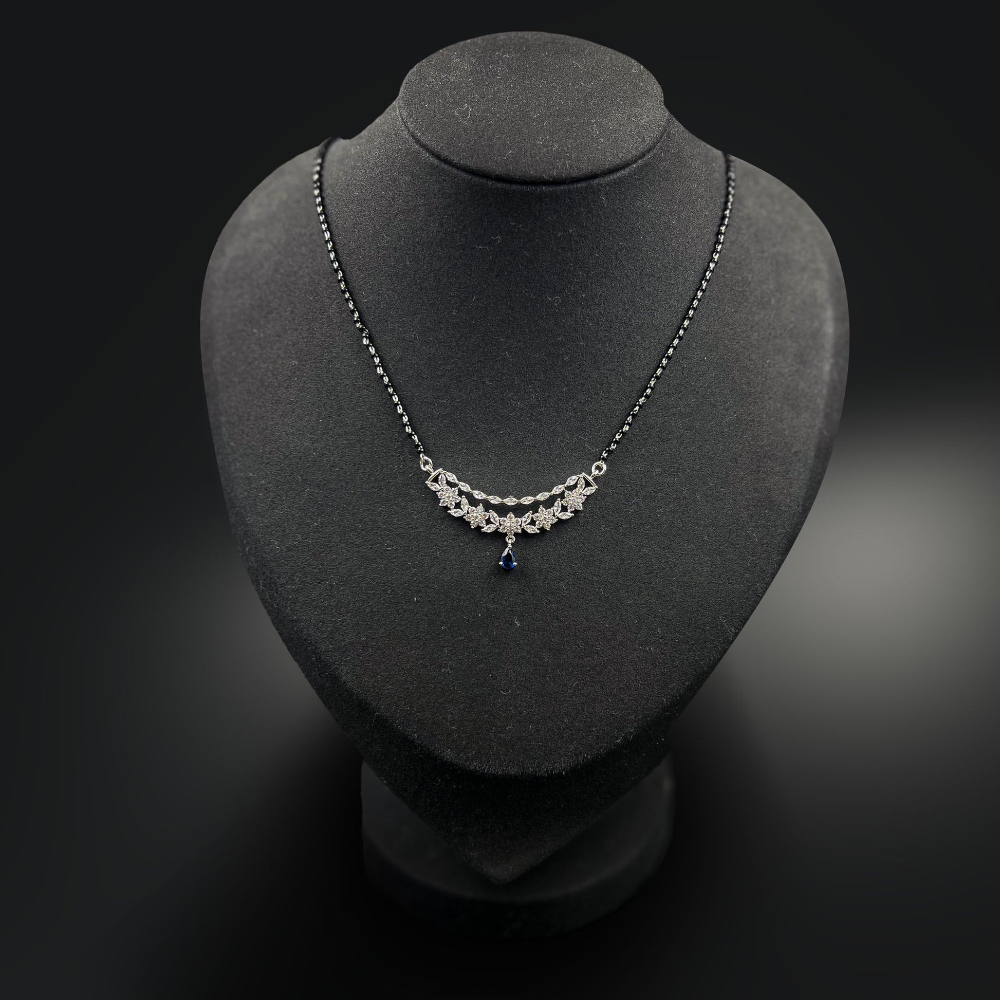 Eternal Blue Mangalsutra with a blue gemstone on a black mannequin