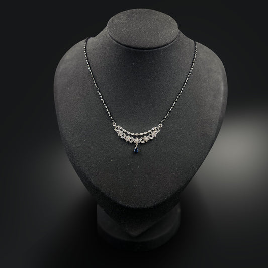 Eternal Blue Mangalsutra with a blue gemstone on a black mannequin