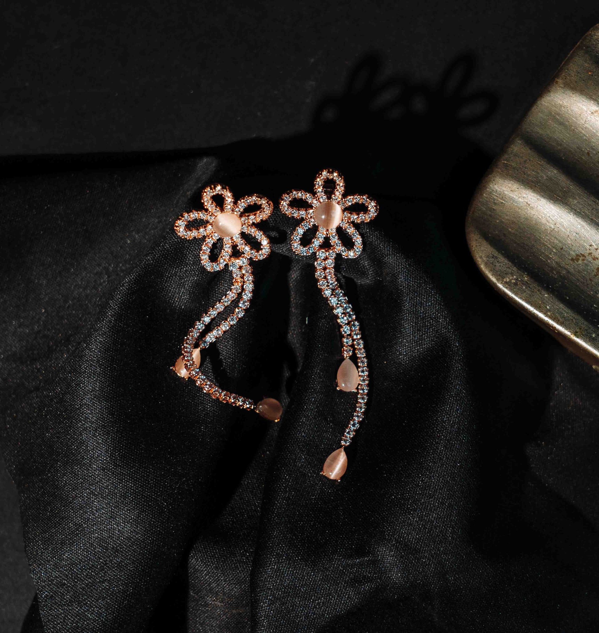 Elfy 925 Sterling Silver Rose Gold Floral Drop Earrings featuring a shimmering flower motif and cascading crystal trails set against a black silk background—A sophisticated and elegant Valentine’s Day gift for 2026.