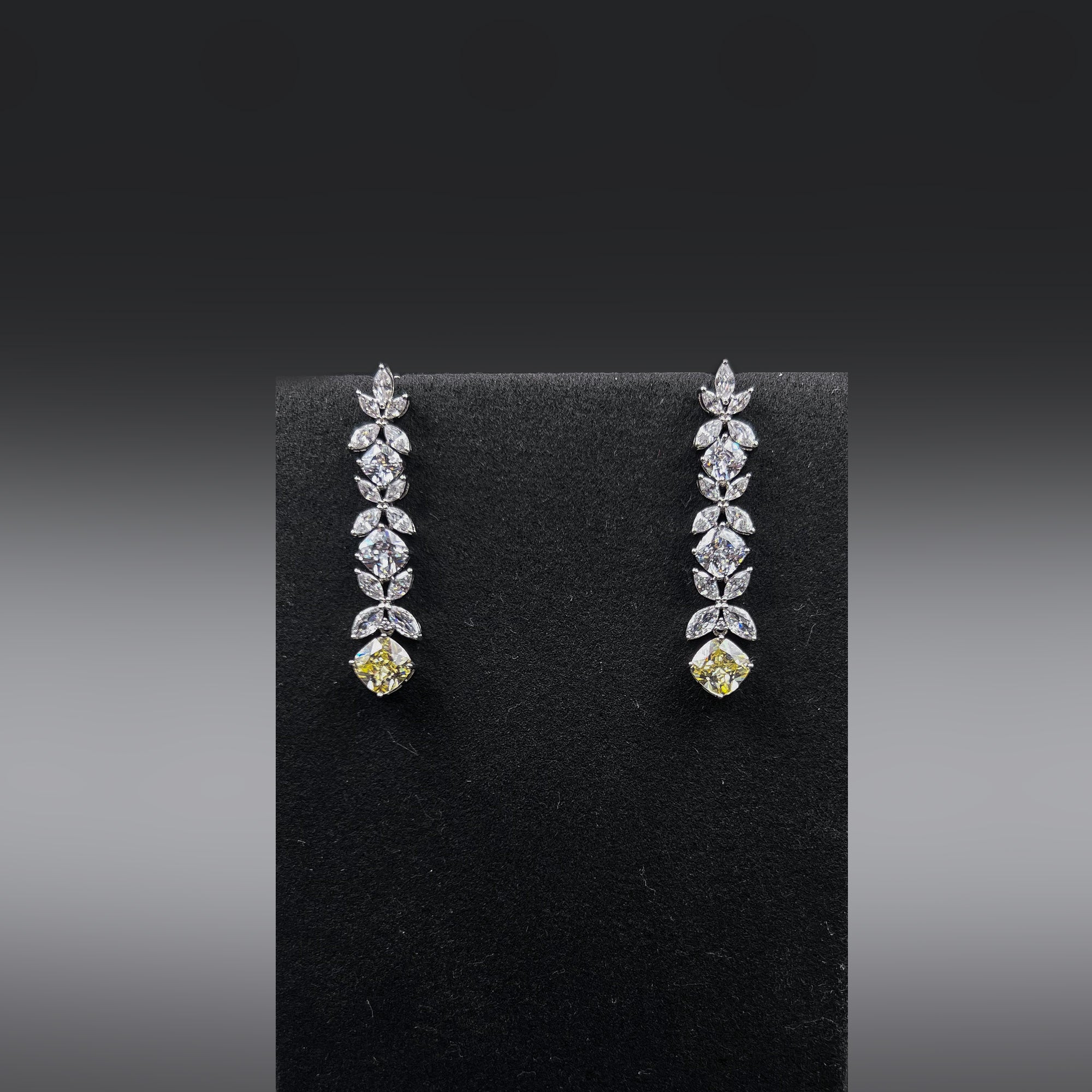 Pair of earrings with high quality white zircon stones and a yellow stone at the bottom