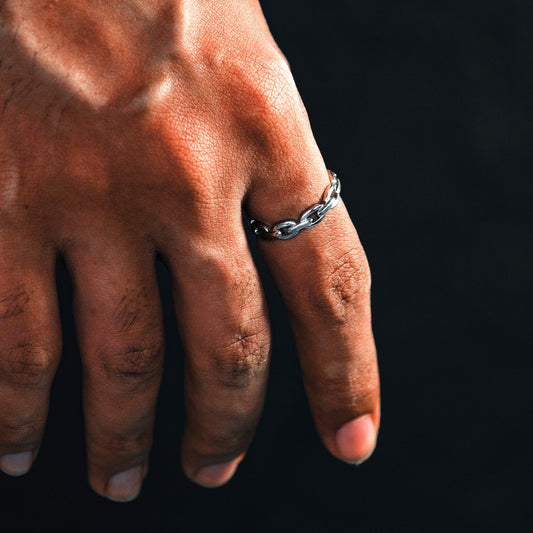 Hand wearing a silver chain ring