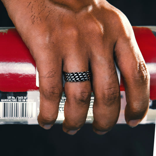 Hand wearing a black woven ring