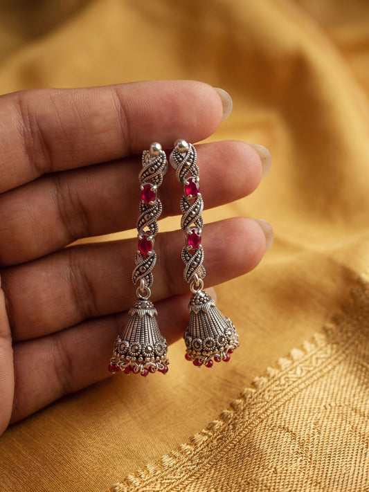Sterling silver earrings with ruby accents for festive and everyday wear.