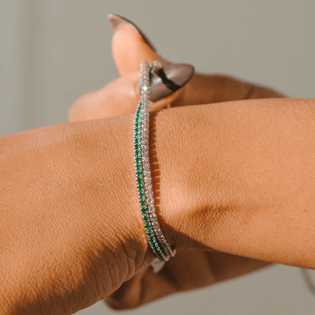 Minimalist Tennis Bracelet, model playing with bracelet on hand