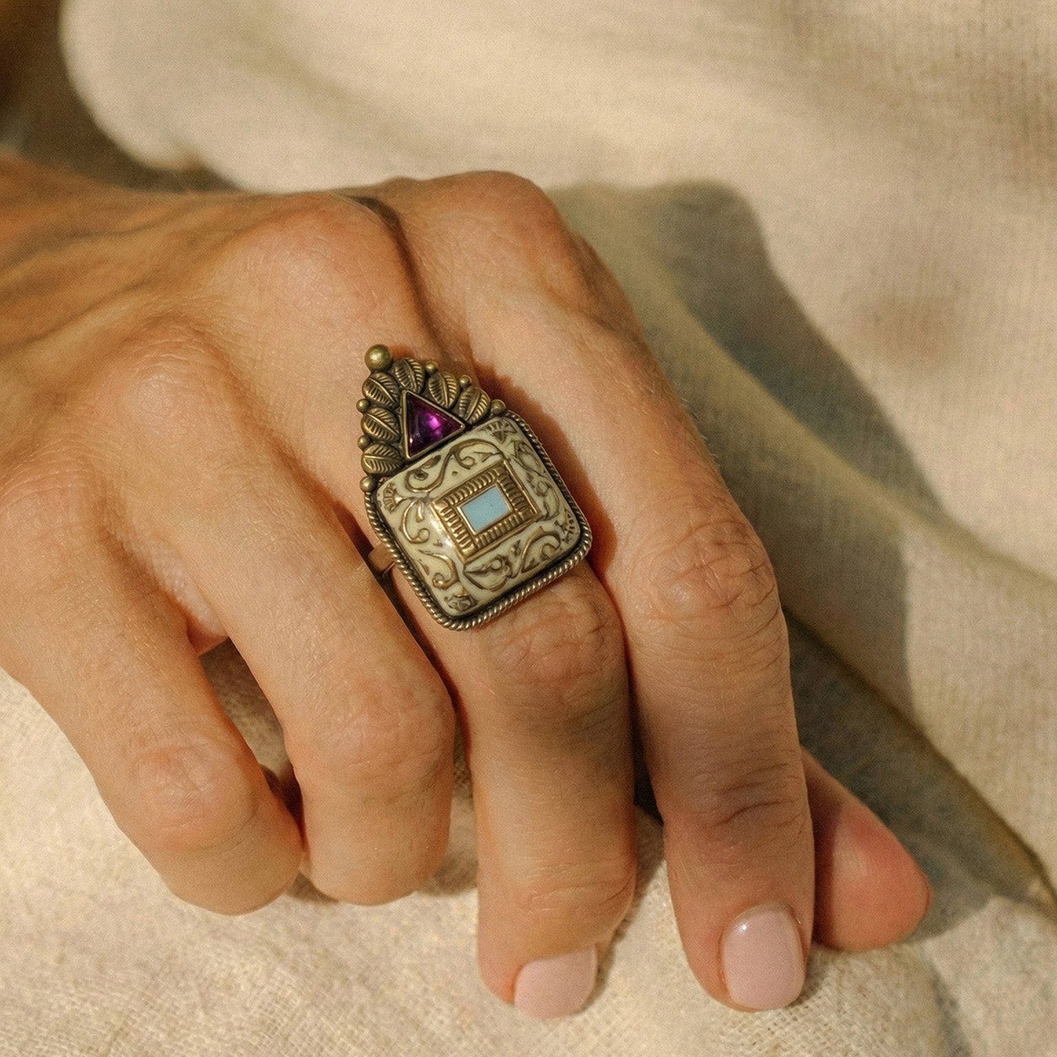 Elfy 925 Sterling Silver Antique Tribal Ring featuring a handcrafted square motif with intricate scrollwork, a central turquoise colored inlay, and a triangular pink gemstone crown. A bold vintage style statement ring for boho fashion