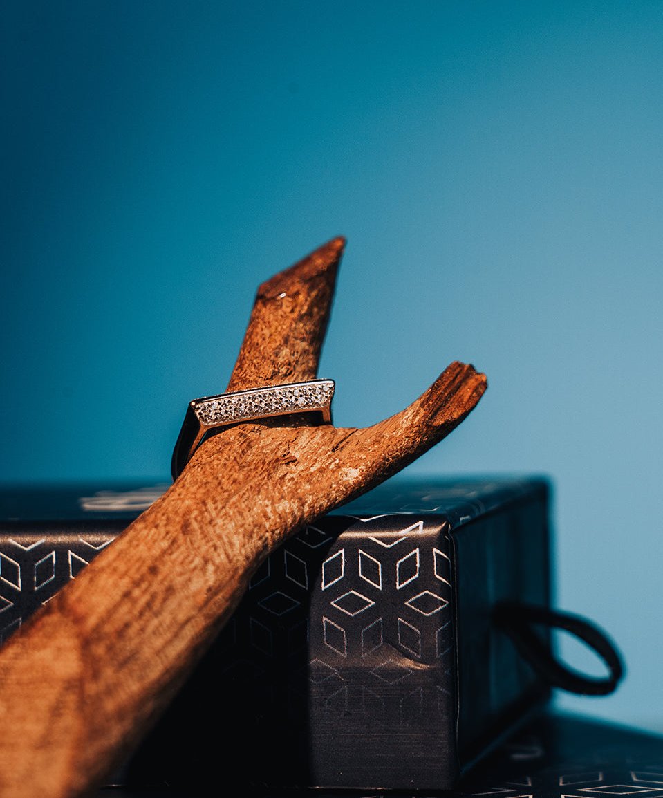 Sterling silver ring with straight line on top and stones on the sides