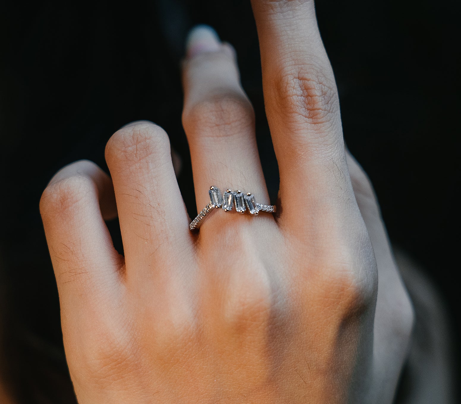 Sterling silver ring with 4 zircon stones placed in center