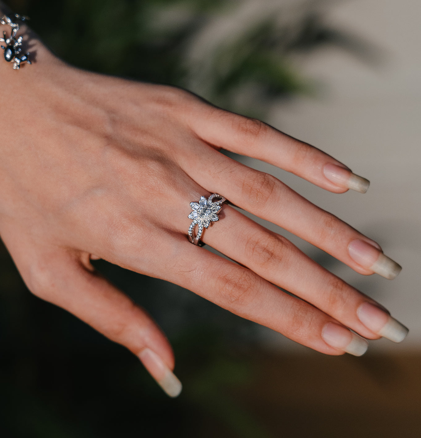 Sterling silver flower ring with bracelet with charms on wrist