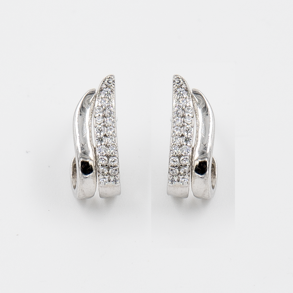 A pair of silver stud earrings featuring a wave shape with one line adorned with cubic zirconia and another line plain.