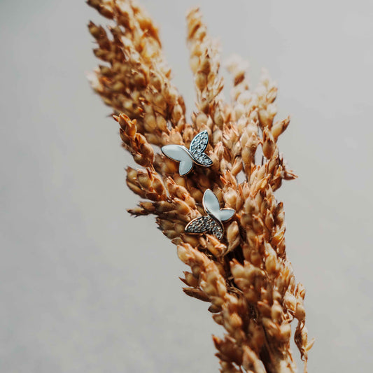 Sterling silver studs in the shape of butterfly with white enamel