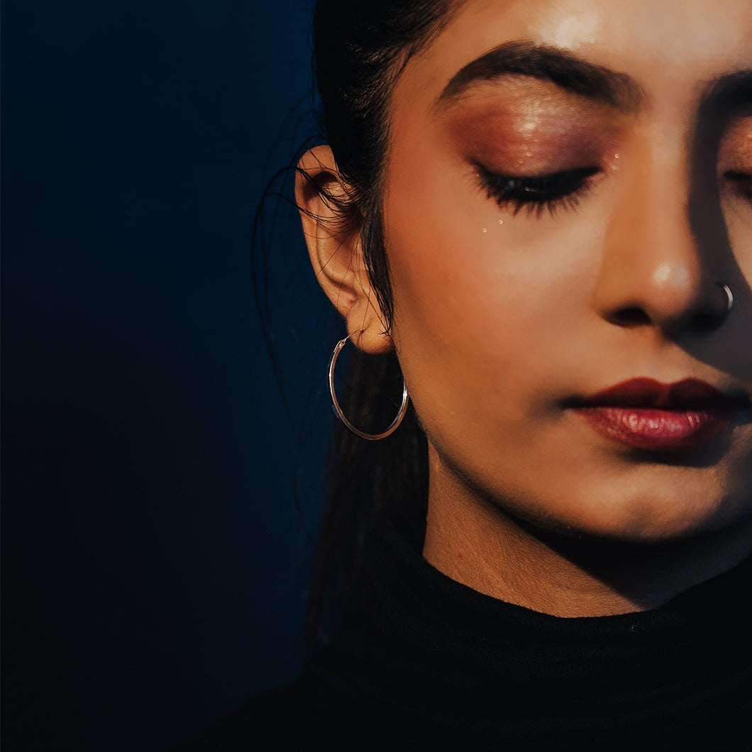 Sterling silver medium size everyday hoop earrings on model