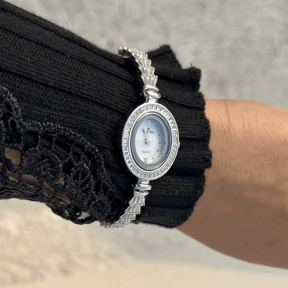 Silver wristwatch with zircon stones and oval dial with stones at the edge of the oval design