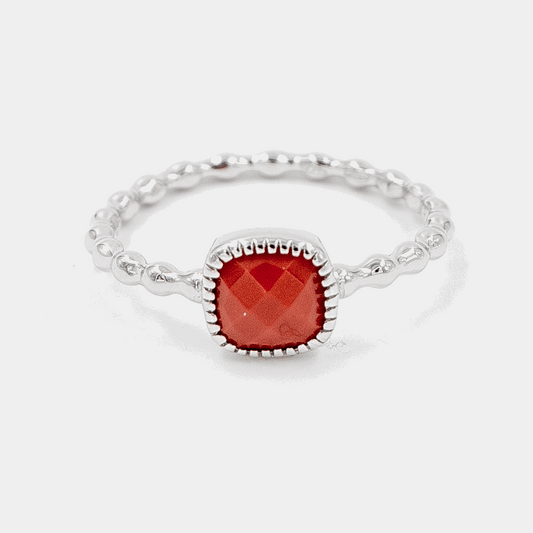 Crimson Drop Ring on white background, the design is shown beautifully and the carving on red stone on the top is shown perfectly.