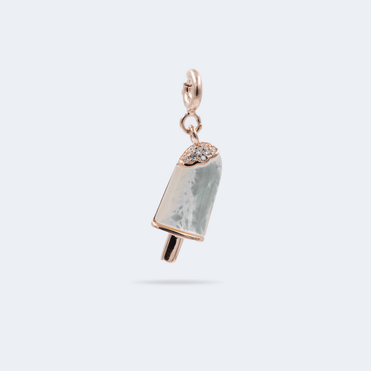 A silver popsicle-shaped charm with a rose gold-colored stick and tip, adorned with small zircon stones on the top and mother of pearl 