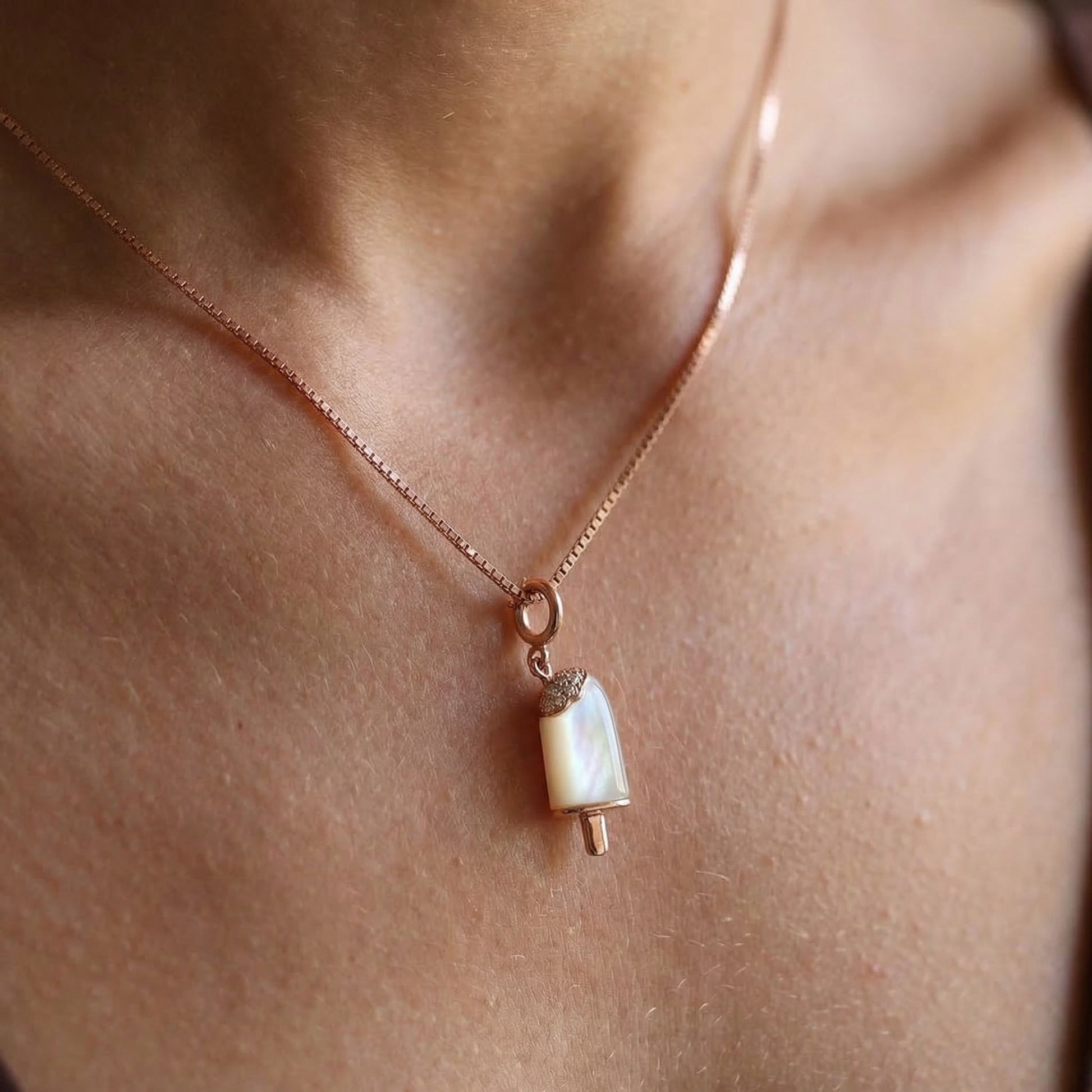 rose gold whisper chain with rose gold ice cream charm worn on a girls neck