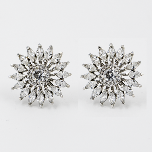 A pair of silver stud earrings designed with a central stone surrounded by leaf-shaped stones creating a sunburst effect.