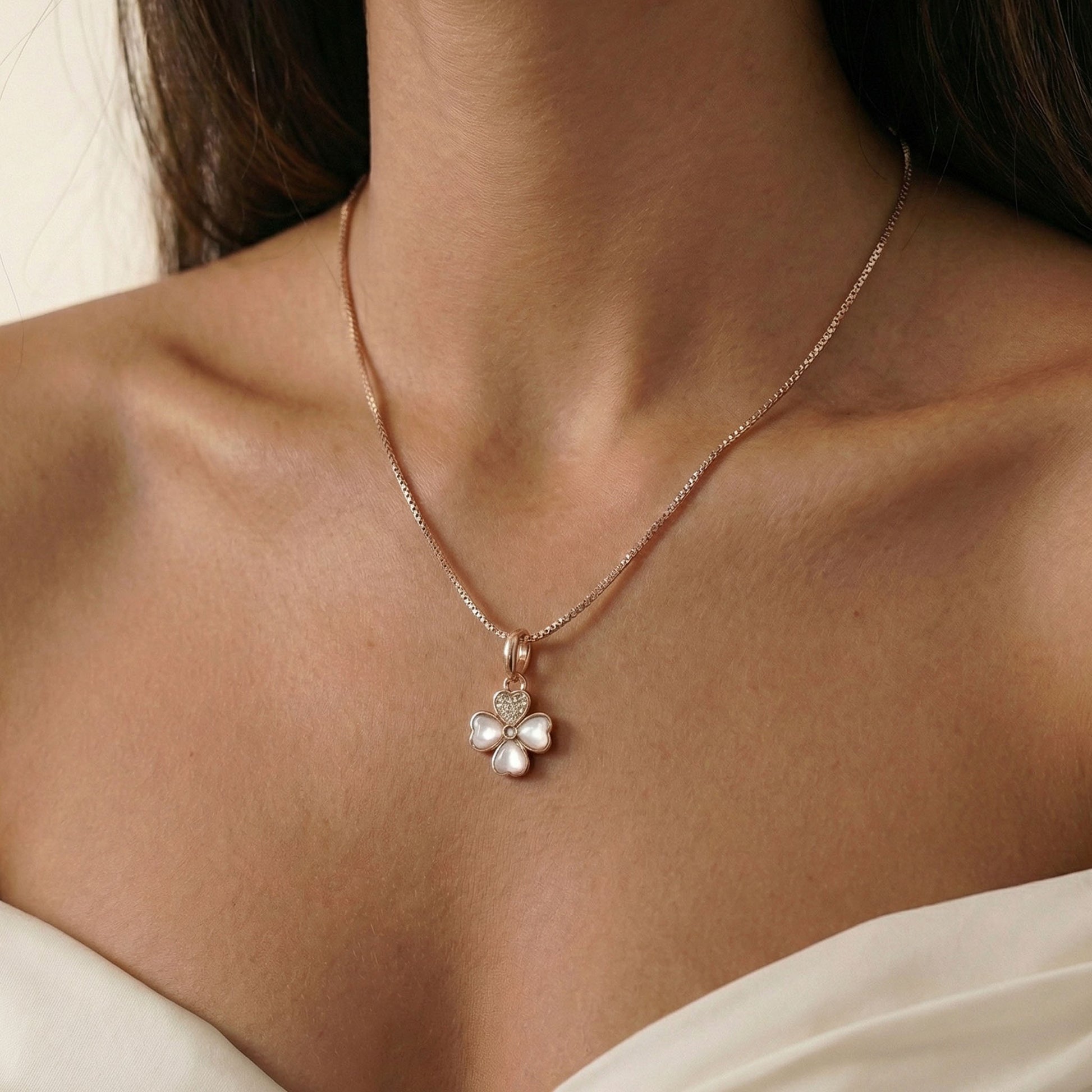 Rose gold whisper chain with a clover-shaped charm on neck, Goodluck charm, Charms, Silver Charms