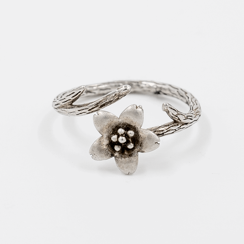 925 Silver Elfy Bloom Ring on white background, it's an oxidized ring with 5 petal flower