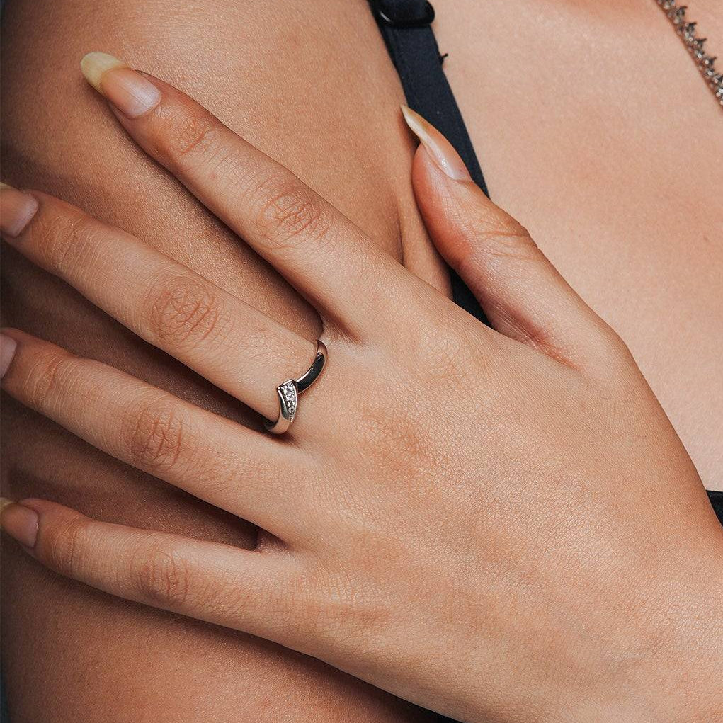 Everyday ring for that perfect everyday worn on a hand of a model which is adjustable and has a triangle design with one side zircon studded.