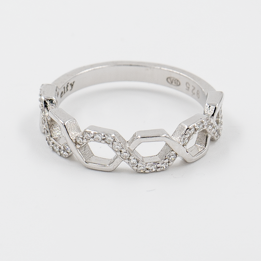 A silver ring with a honeycomb-inspired design, featuring interlocking hexagons and a halo of zircon stones around the band.