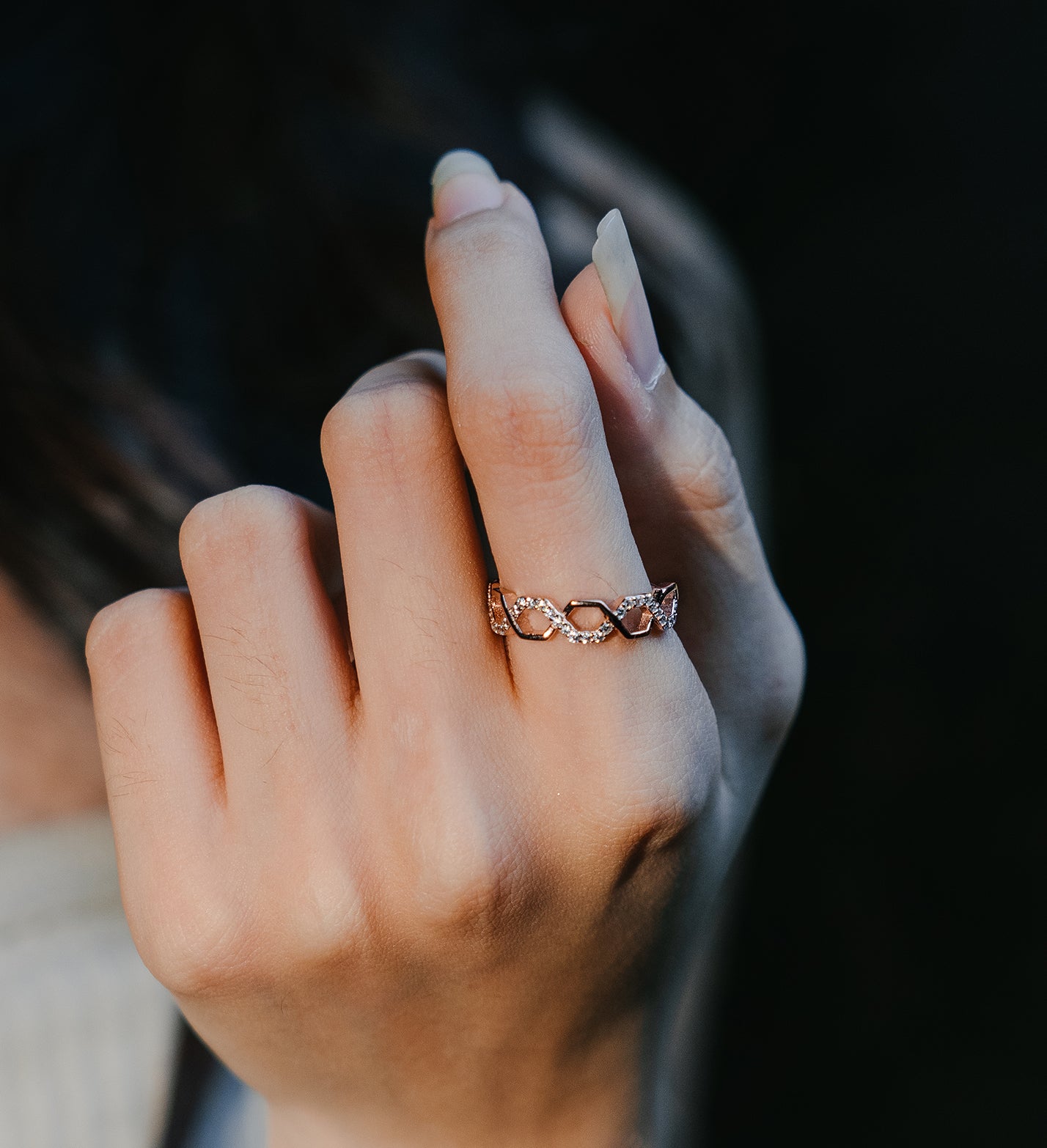 Sterling silver rose gold honeycomb ring worn on a model finger in rose gold