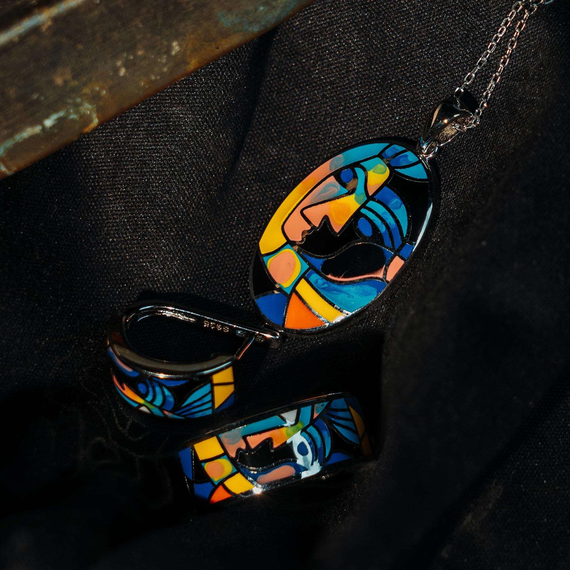 A sterling silver enamel set with pendant earrings and ring set with print of a modern muse. an intricate modern design aesthetic enameled on the pendant