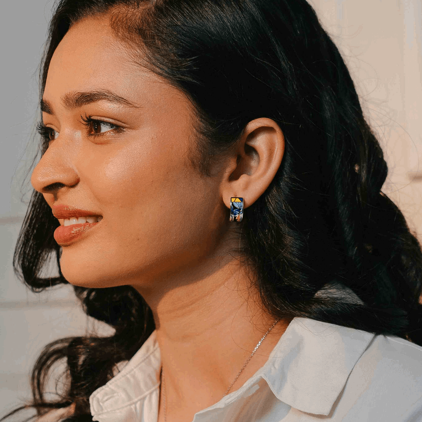A sterling silver enamel set with pendant earrings and ring set with print of a modern muse.in this picture only earrings are shown