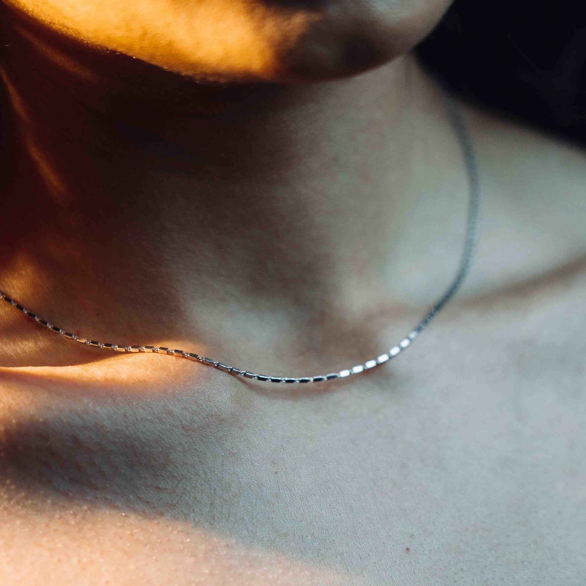 A sterling silver chain which has tiny rectangles interlocked