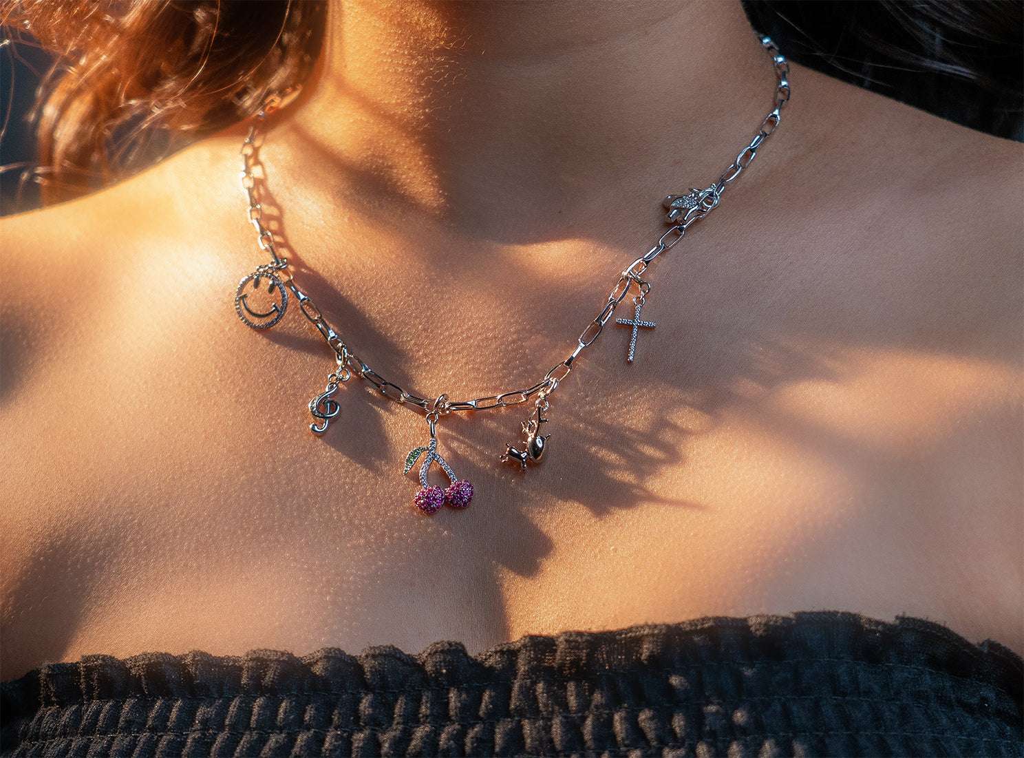 Elfy 925 Sterling Silver Paperclip Charm Chain for women and men, featuring symbolic charms including a treble clef, smiley face, cross, reindeer, elephant and sparkling cherry. A modern handcrafted jewellery piece.