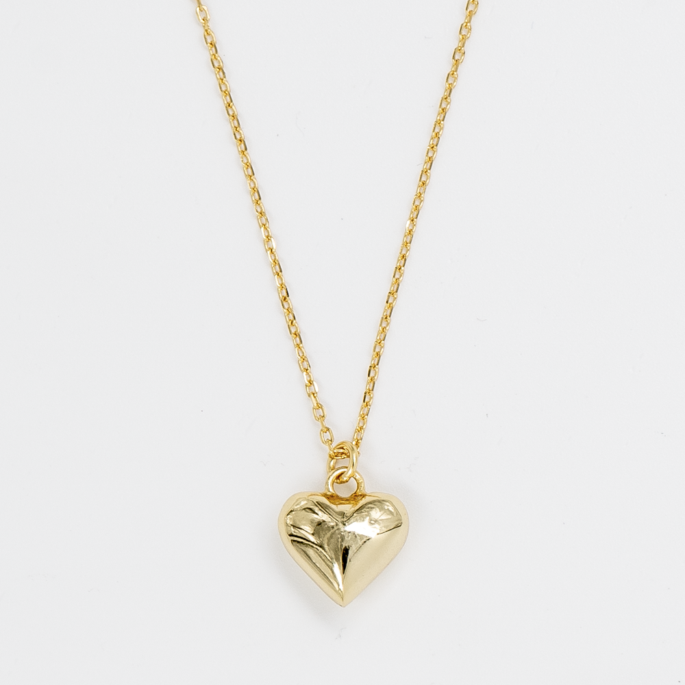 A gold-plated heart-shaped pendant on a gold-plated chain against a white background.