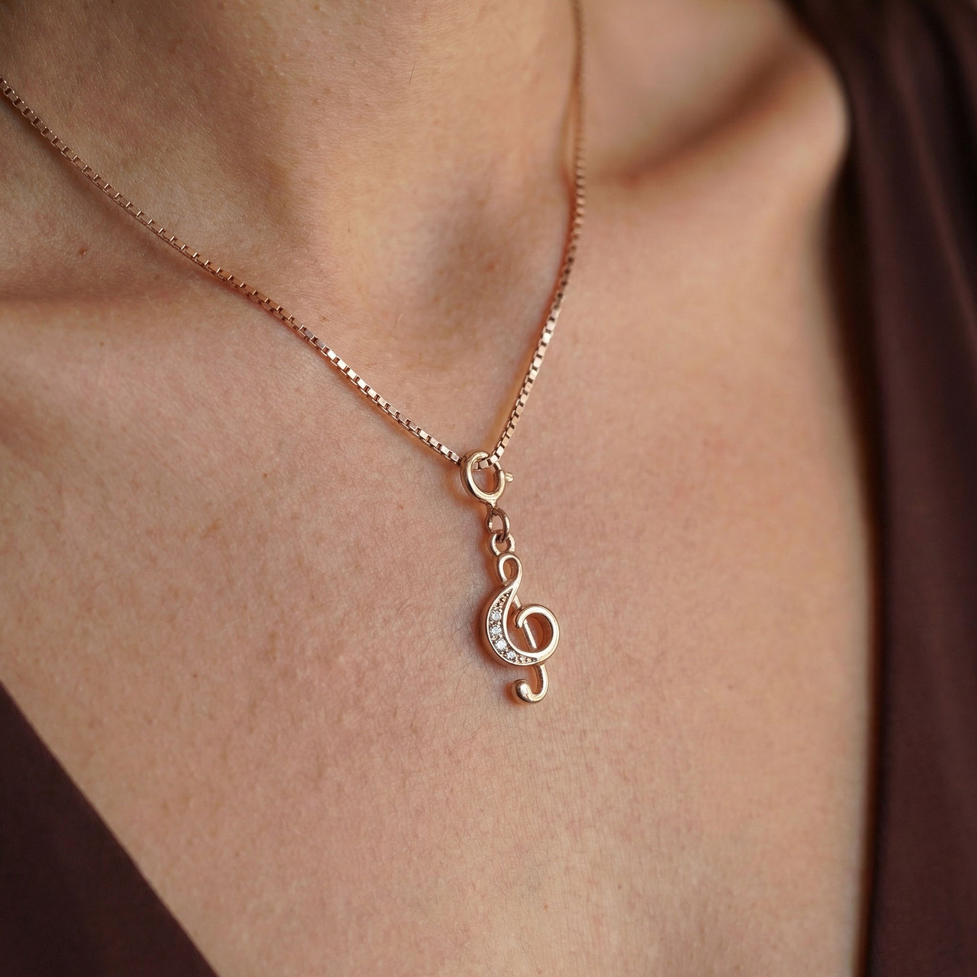 Close up of elfy's Pure 925 silver clef charm in rose gold plating