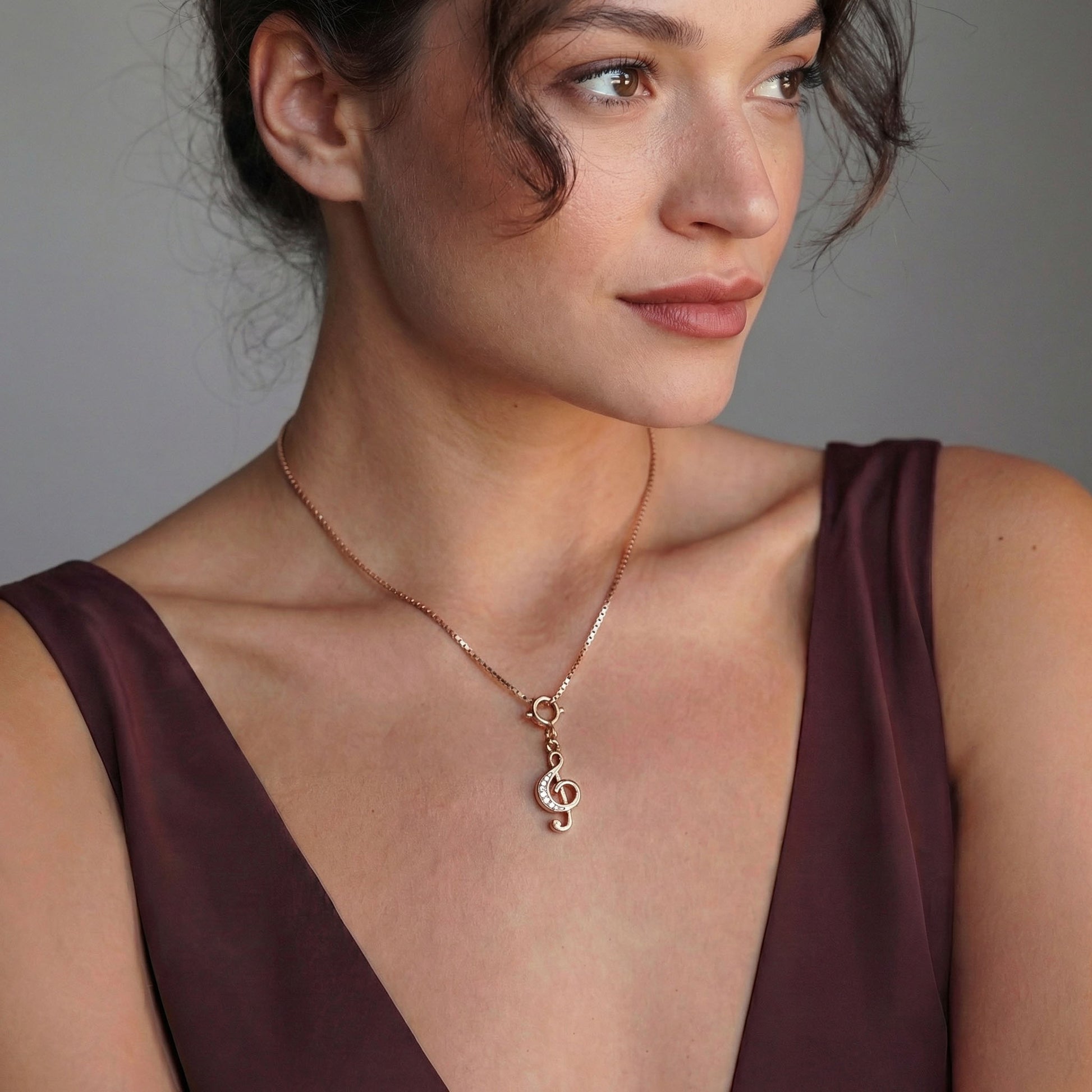 Silver Clef Charm worn as a pendant on a chain, Rose gold plating, Charms