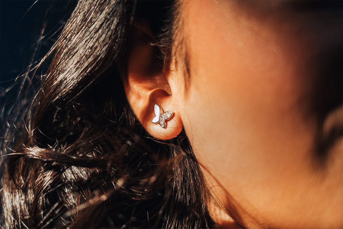 Sterling silver studs in the shape of butterfly with white enamel