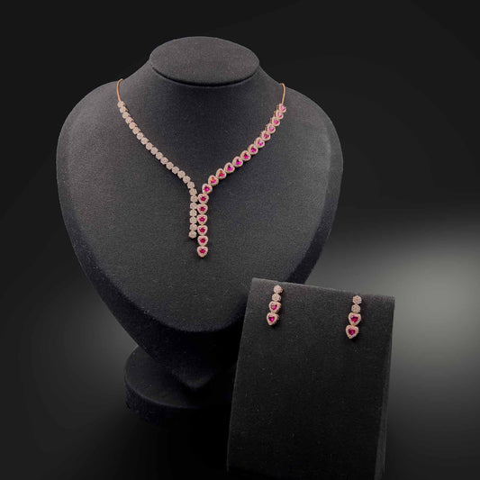 Jewellery set with necklace and earrings on a black mannequin. the earrings has 2 circle first with white stones and 2 heart shaped ruby stones down them.