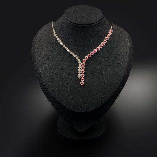 Necklace with red and clear stones on a black stand