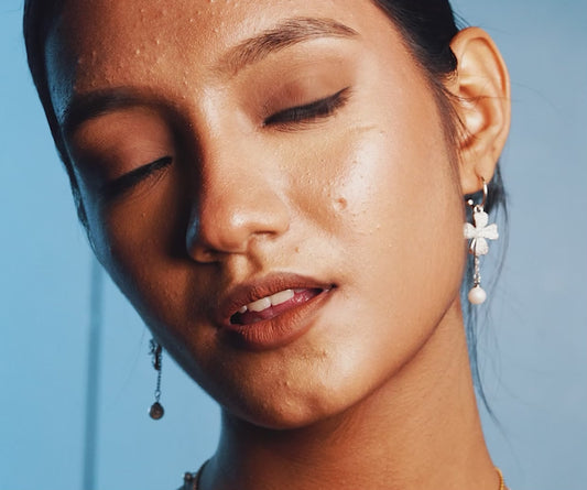 Model wearing a gold ring with opal stones