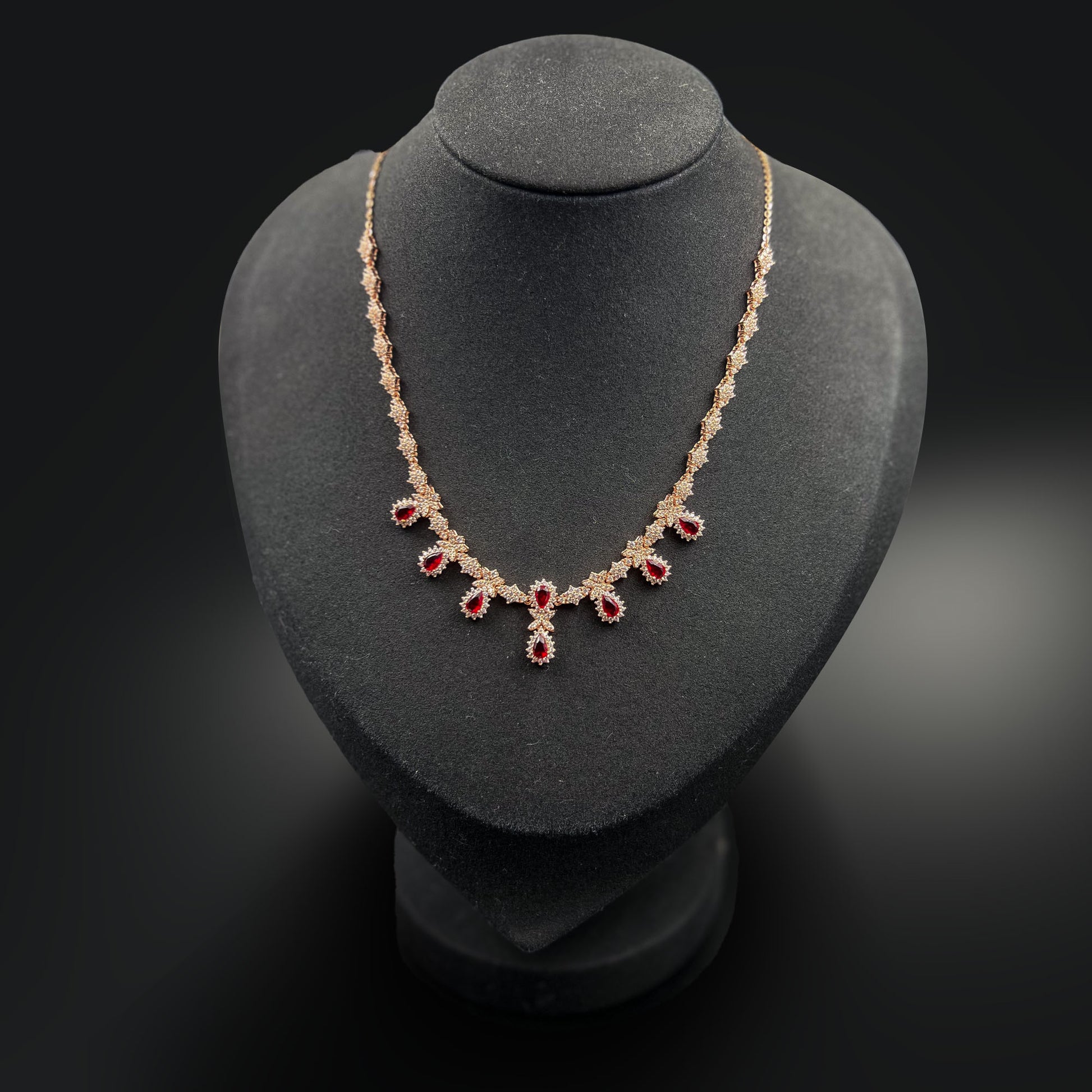 Necklace with red gemstones on a display stand